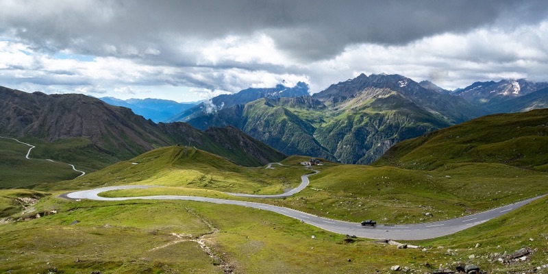 The Grossglockner High Alpine Road curving through alpine meadow below the peaks