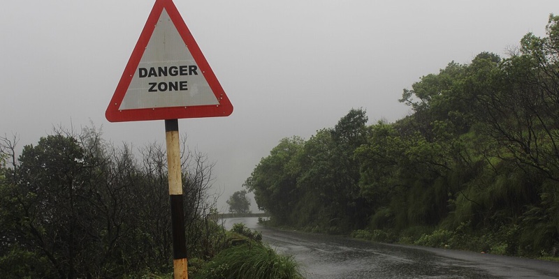 A wet ghat road disappearing into mist in the Western Ghats